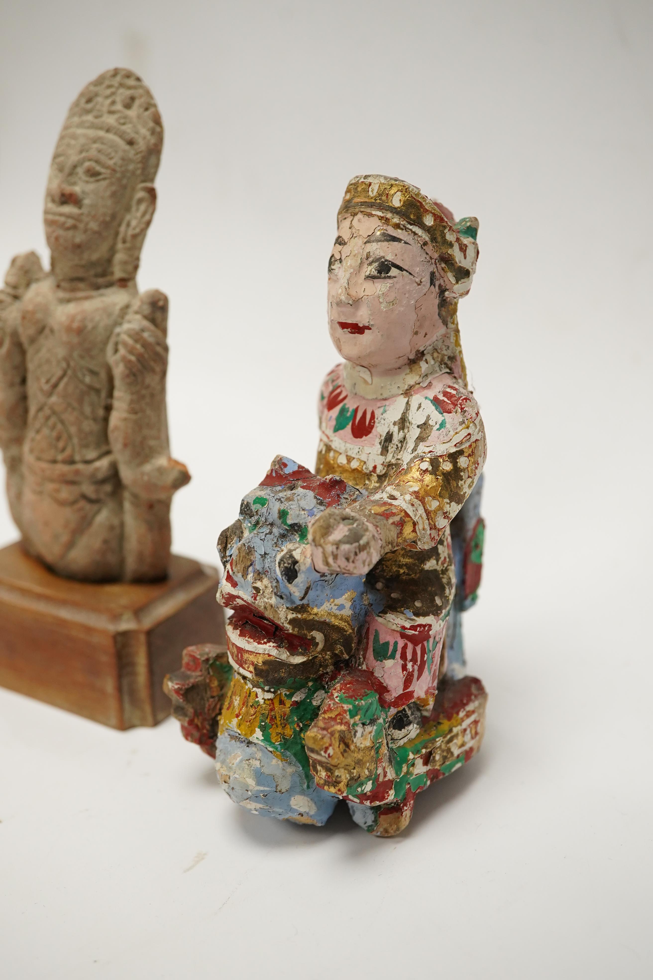 A Burmese lacquered wood figure, 19th century and an Indian terracotta figure of a deity, largest 13cm high overall. Condition - fair